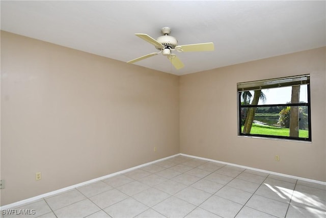 tiled empty room featuring ceiling fan