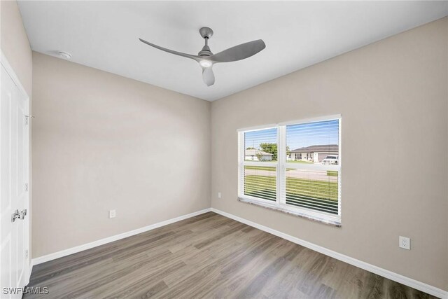 unfurnished room with ceiling fan and wood-type flooring