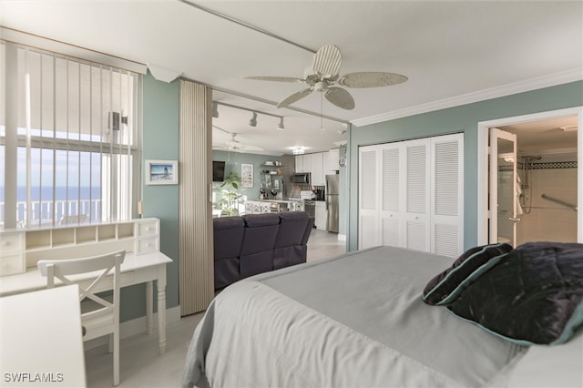 bedroom featuring a closet, ceiling fan, crown molding, and stainless steel refrigerator