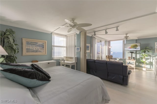 bedroom with light wood-type flooring, ceiling fan, track lighting, and ornamental molding