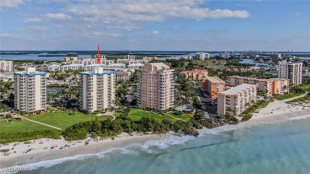 birds eye view of property with a beach view and a water view