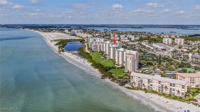 drone / aerial view with a beach view and a water view