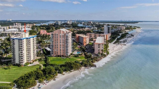 drone / aerial view with a beach view and a water view