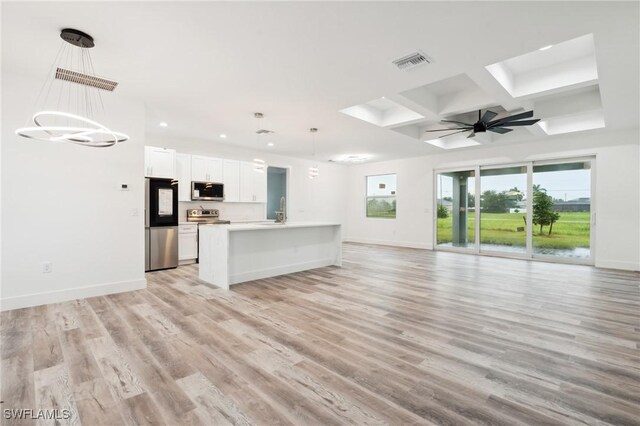 kitchen with decorative light fixtures, light wood-type flooring, coffered ceiling, white cabinetry, and stainless steel appliances