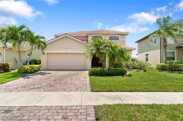 mediterranean / spanish-style house with a garage and a front lawn