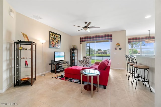 living room featuring ceiling fan and light tile patterned flooring