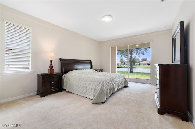 bedroom with light carpet and access to exterior