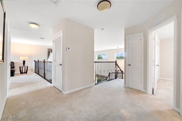 corridor with light colored carpet