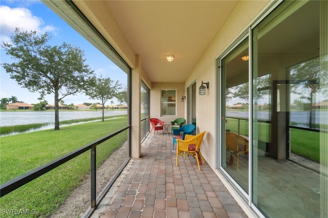 unfurnished sunroom featuring a water view