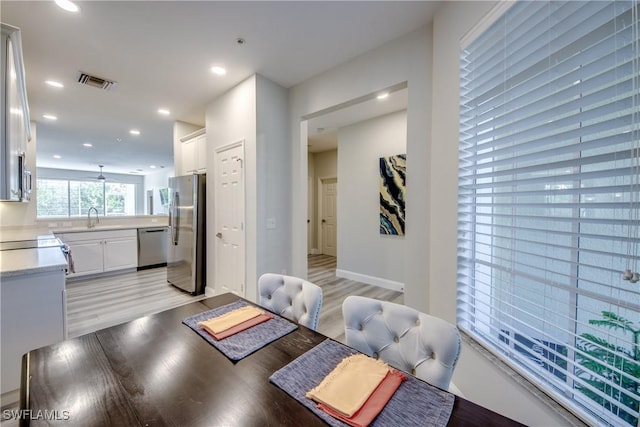 interior space with sink and light hardwood / wood-style flooring