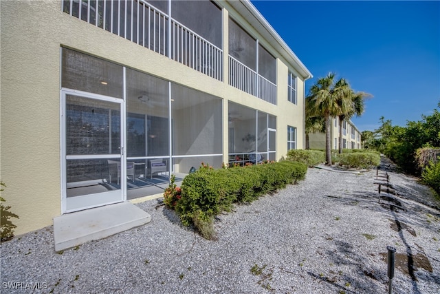 view of side of property featuring a sunroom