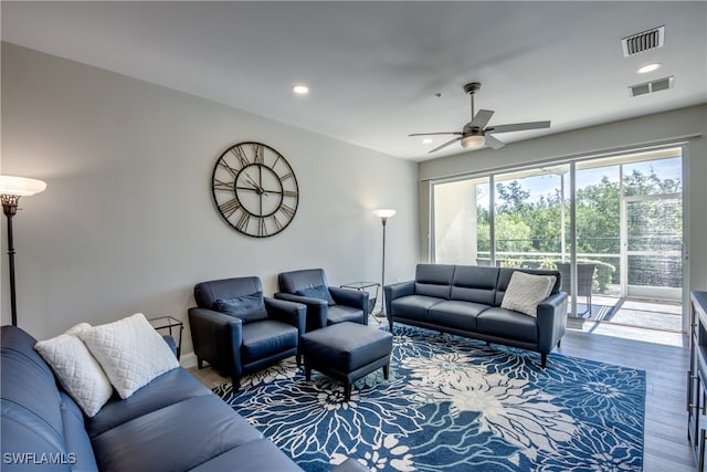 living room featuring ceiling fan and wood-type flooring