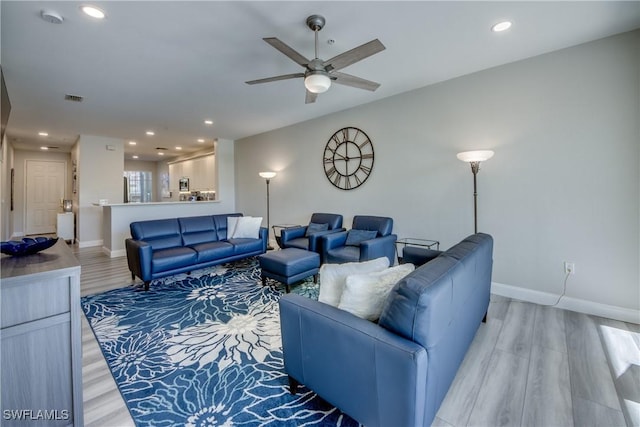 living room featuring ceiling fan and light wood-type flooring