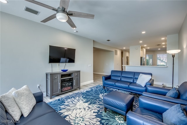 living room featuring ceiling fan and hardwood / wood-style floors