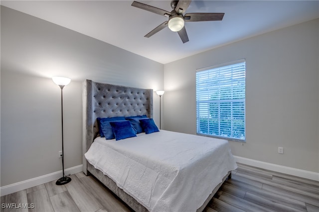 bedroom with ceiling fan and hardwood / wood-style floors