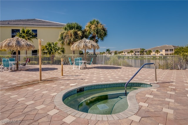 view of pool featuring a hot tub and a patio