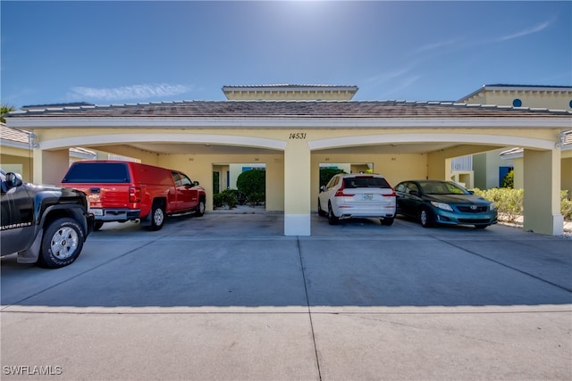 view of vehicle parking with a carport