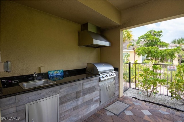 view of patio with area for grilling, a grill, and sink