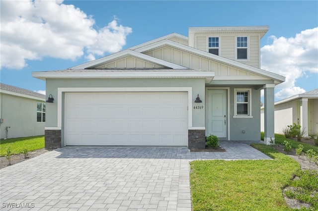 craftsman-style home featuring a garage and a front lawn