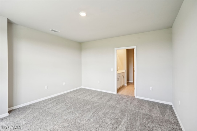 empty room featuring light carpet