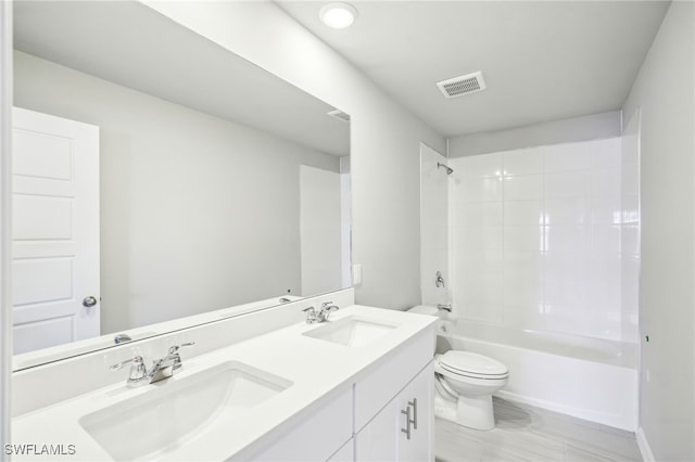 full bathroom with vanity, tiled shower / bath combo, and toilet