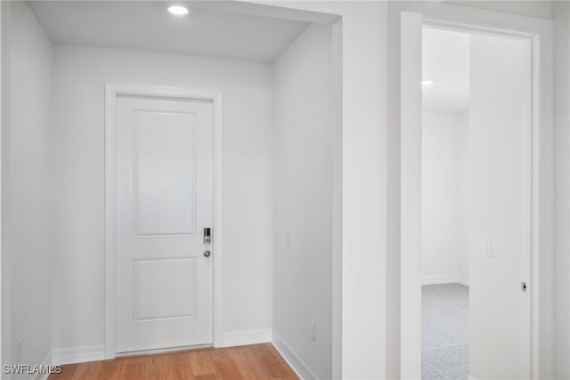 corridor with light hardwood / wood-style flooring