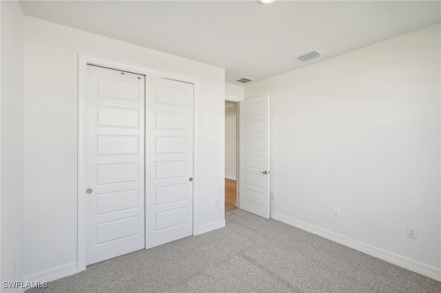 unfurnished bedroom with a closet and carpet floors