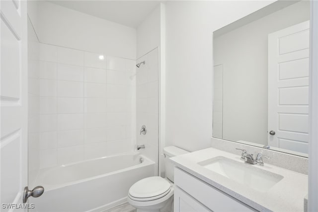 full bathroom with tiled shower / bath combo, vanity, and toilet