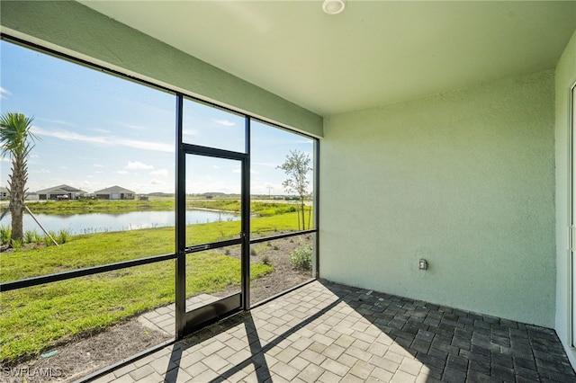 sunroom / solarium with a water view