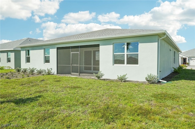 back of house featuring a sunroom and a yard