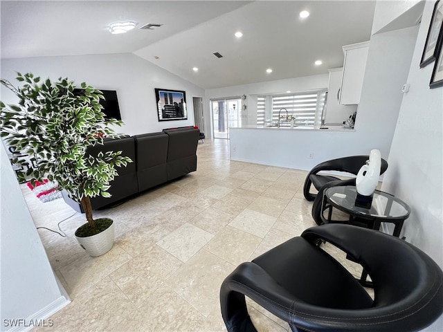 interior space featuring sink, lofted ceiling, and light tile patterned flooring