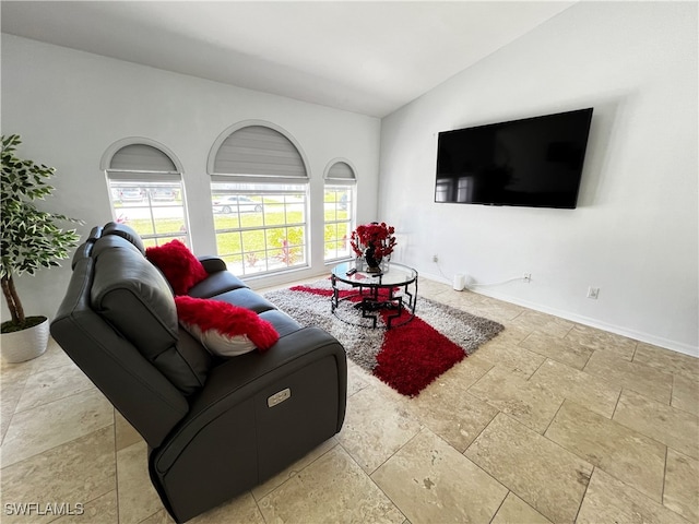 living room featuring lofted ceiling and tile patterned floors