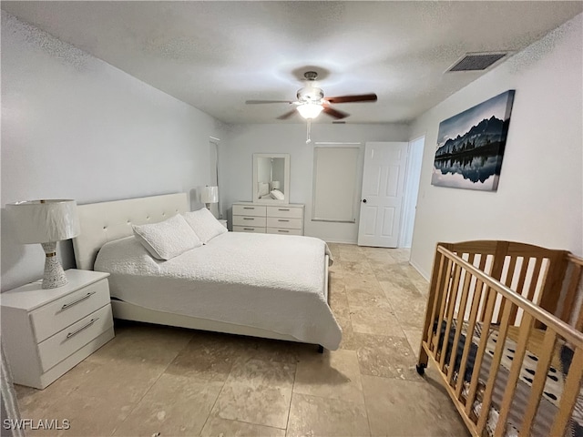 bedroom with ceiling fan and light tile patterned floors