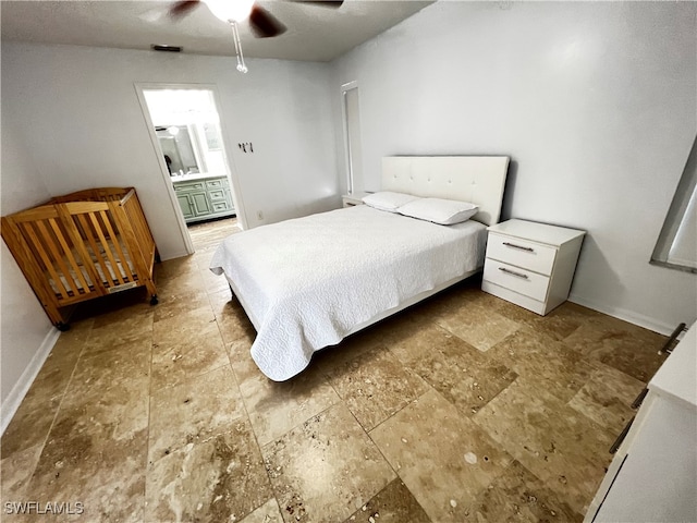 tiled bedroom featuring ceiling fan and ensuite bath