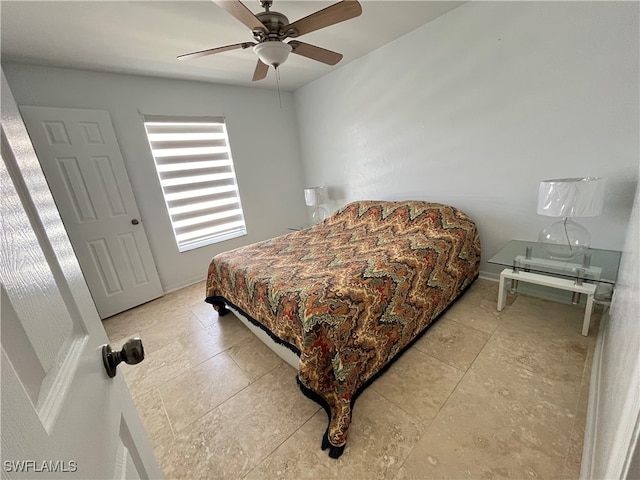 tiled bedroom featuring ceiling fan