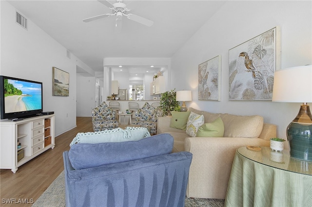 living room featuring hardwood / wood-style flooring and ceiling fan