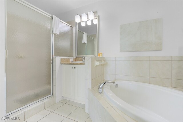 bathroom with separate shower and tub, vanity, and tile patterned floors