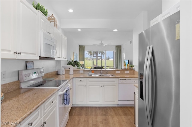 kitchen featuring white cabinetry, light hardwood / wood-style flooring, ceiling fan, and white appliances