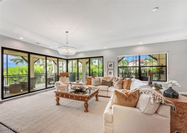 carpeted living room featuring a chandelier