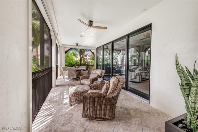 sunroom / solarium featuring ceiling fan