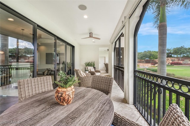 sunroom featuring ceiling fan