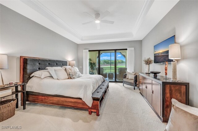 bedroom featuring a raised ceiling, ceiling fan, light colored carpet, and access to outside