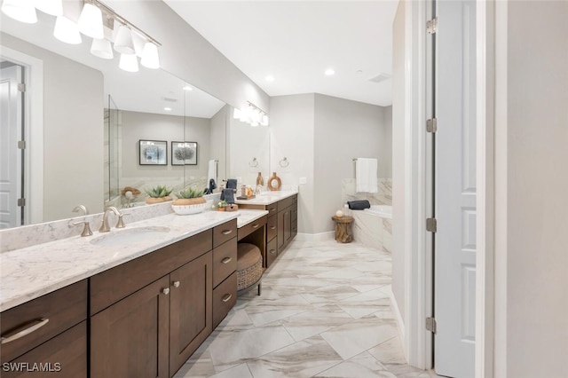 bathroom featuring baseboards, marble finish floor, a garden tub, vanity, and recessed lighting