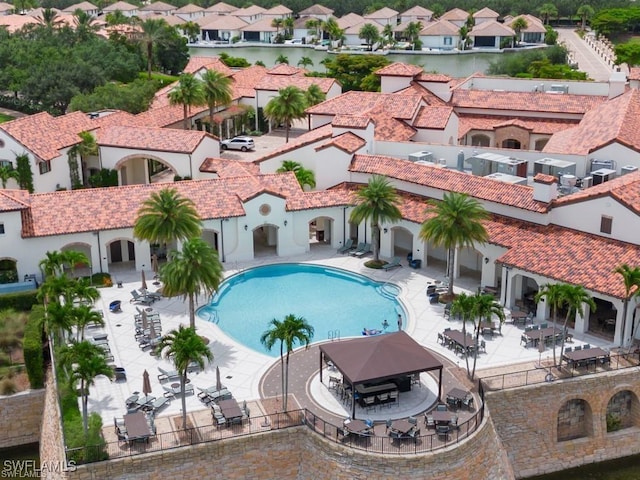 community pool featuring a patio area and a residential view