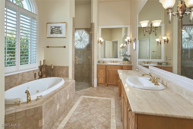 bathroom with plus walk in shower, tile patterned flooring, and double sink vanity