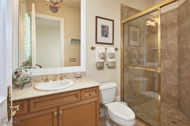 full bath with a stall shower, vanity, and toilet