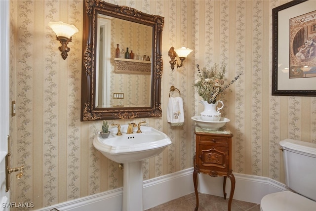 bathroom featuring toilet, wallpapered walls, and tile patterned floors