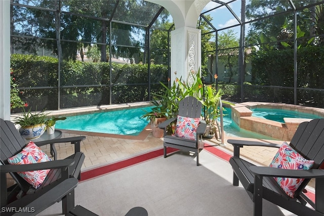 view of pool featuring a patio, a lanai, and a pool with connected hot tub