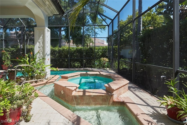 view of swimming pool featuring a lanai and an in ground hot tub