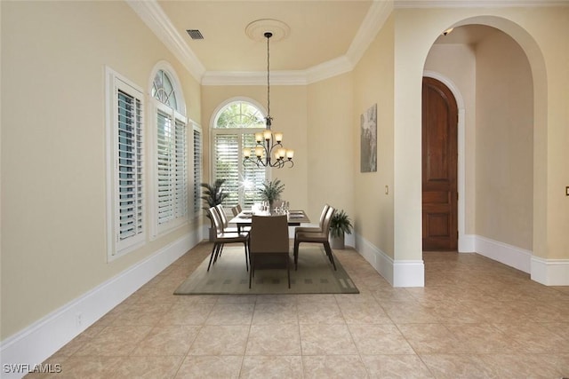 dining space with arched walkways, a notable chandelier, visible vents, baseboards, and ornamental molding